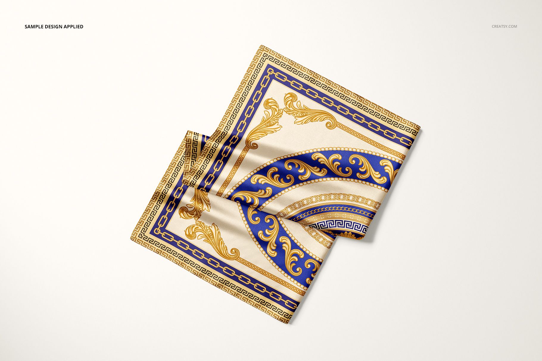 PSD mockup of a satin scarf with decorative blue and gold border design, arranged neatly on a flat surface.