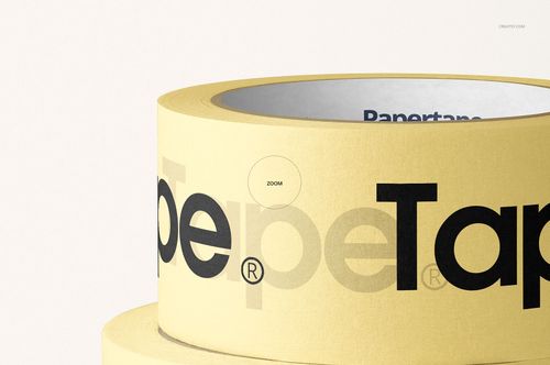 Stacked masking tape rolls in a PSD mockup, featuring a yellow color and large black lettering on a plain background.