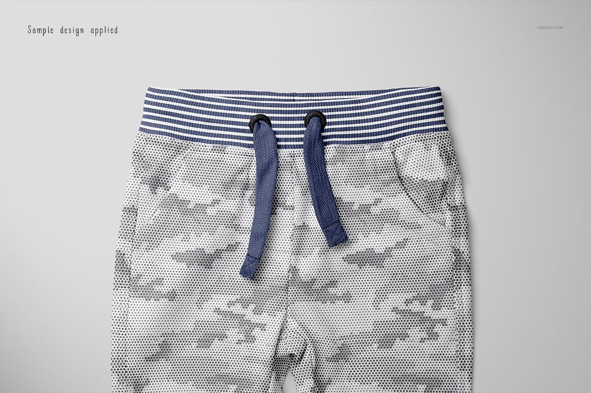 Front view of baby sweatpants mockup with blue striped waistband and drawstrings, featuring a gray camouflage pattern.
