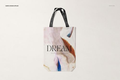 Front view of a shopper canvas bag mockup with abstract marble pattern in pastel tones and black handles.