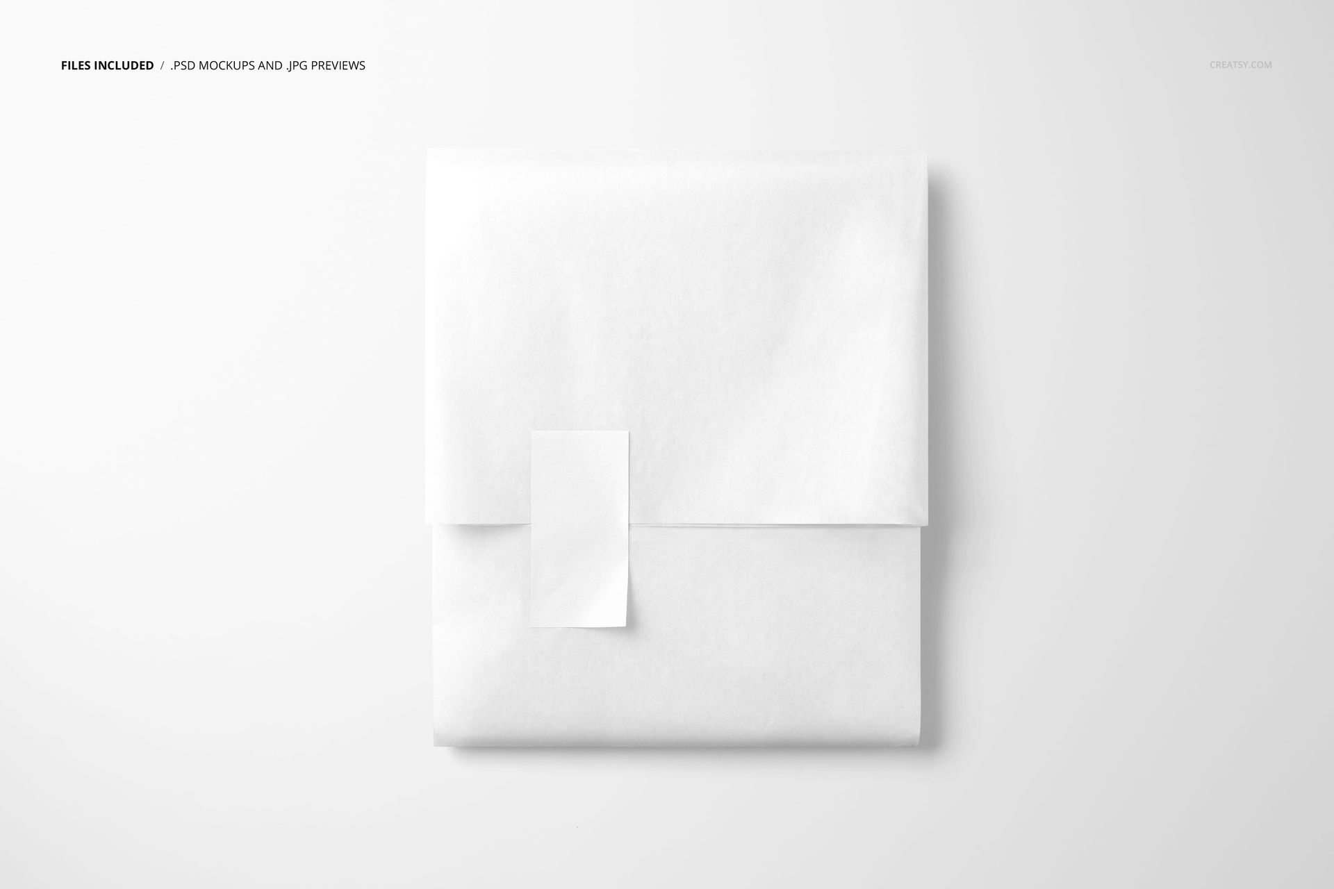 PSD mockup of a square-shaped package wrapped in white tissue paper, featuring a vertical rectangular sticker on top.
