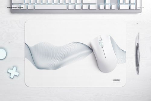 Rectangular gaming mouse pad mockup with rounded corners, featuring a subtle wave pattern, top view on desk.