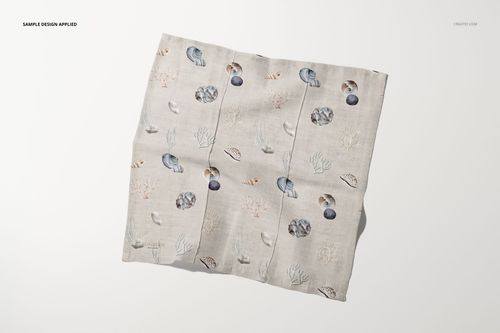 Cotton linen napkin mockup featuring a light beige fabric with seashell and coral pattern, top view on white surface.