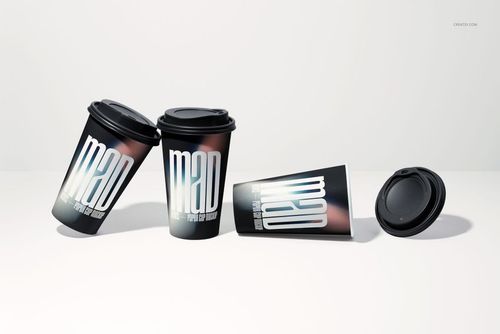 Paper cup PSD mockup showing three cups with dark lids and large white lettering, plus a separate lid on the right.