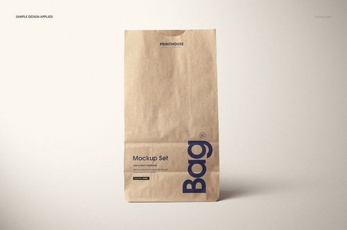 Kraft paper lunch bag mockup featuring simple blue typography, shown upright against a light, plain backdrop.