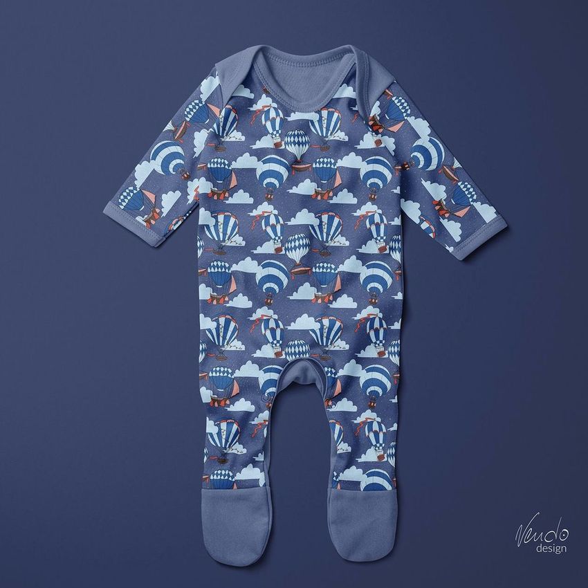 Baby chest rompersuit mockup displayed flat on a solid blue background, featuring a hot air balloons pattern in blue and white.