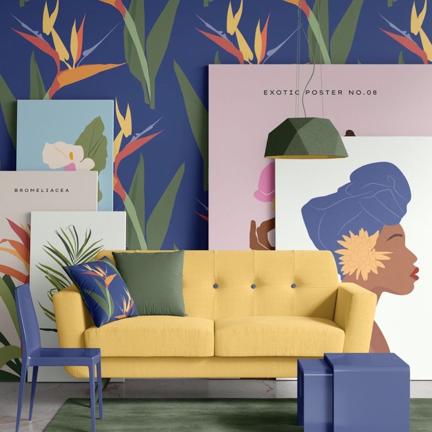 Modern sofa mockup featuring a yellow couch with colorful pillows, surrounded by botanical posters against a floral wallpaper.
