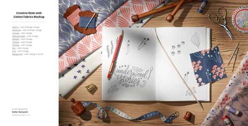 Flat lay of cotton textile mockup featuring patterned fabric swatches, sketchbook, colored pencil, and sewing props.