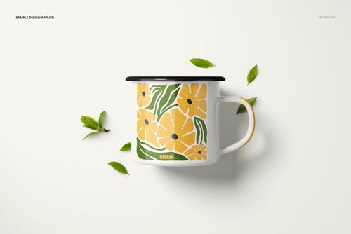 PSD mockup of a 360ml enamel mug with yellow flowers and green leaves, displayed on a light background.