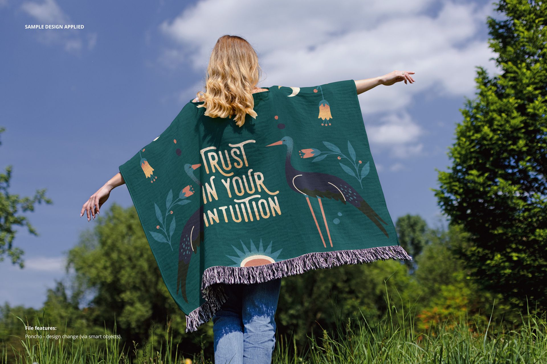 Back view of a person in a woven poncho mockup featuring a dark green color, fringe hem, and graphic artwork.
