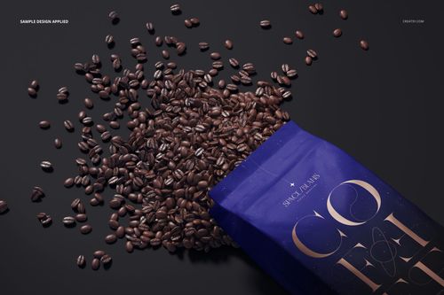 Matte coffee bag mockup with dark blue packaging, shown from a top angle with coffee beans spilling out.