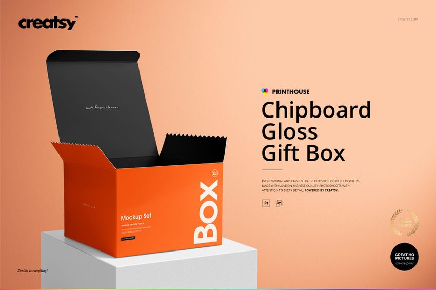 Front view of an open chipboard gloss gift box mockup with black interior and bright orange exterior on a peach background.