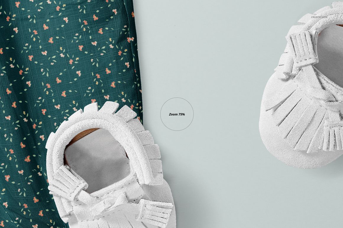 PSD mockup featuring floral-patterned baby harem pants and white moccasin shoes arranged on a soft light backdrop.
