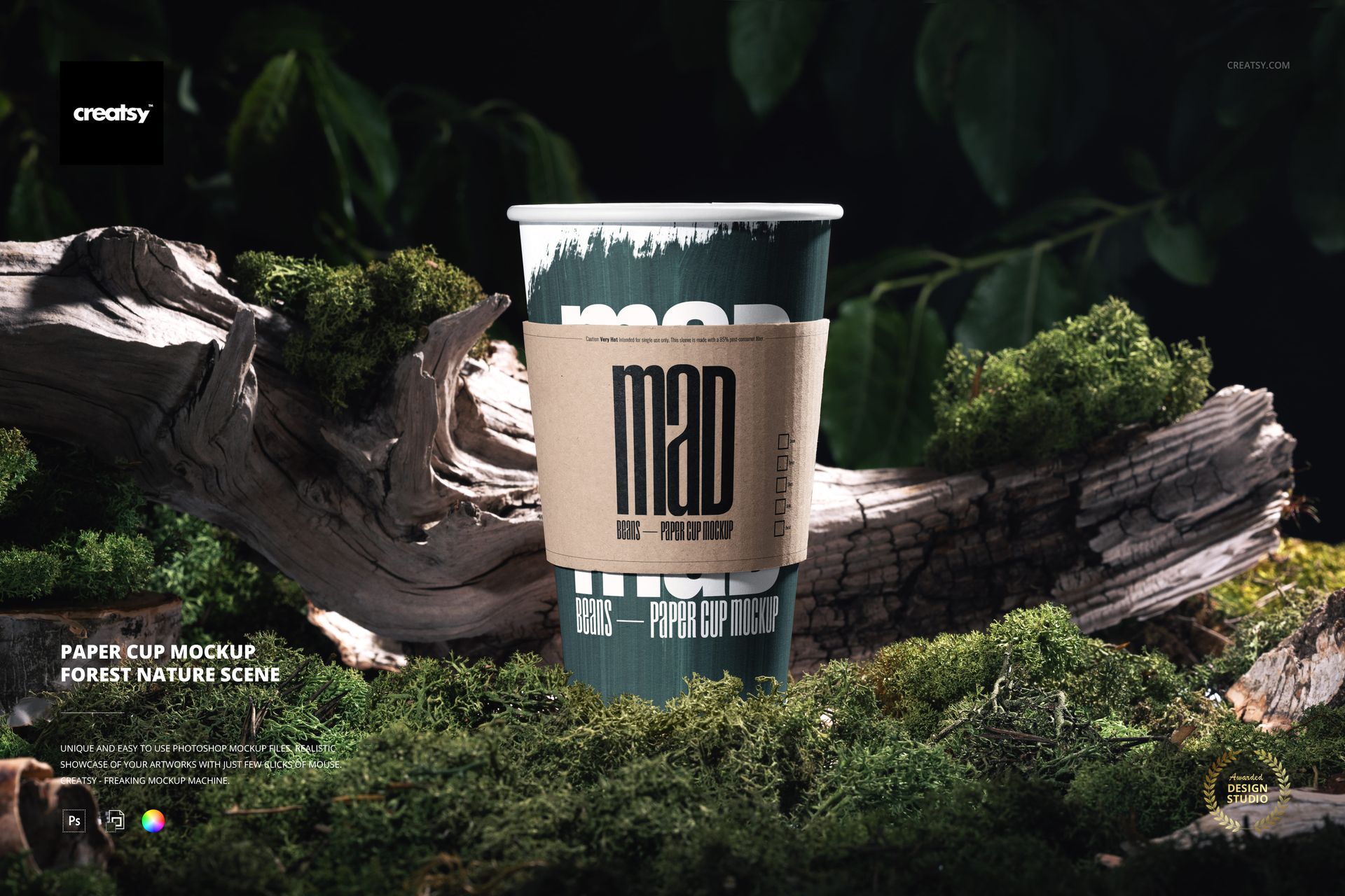 Front view of a paper cup mockup with a brown sleeve, set on a log in a forest scene with rich greenery.