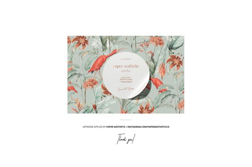 Rectangular home decor textile with a botanical pattern in green and orange tones, shown in a front view mockup scene.