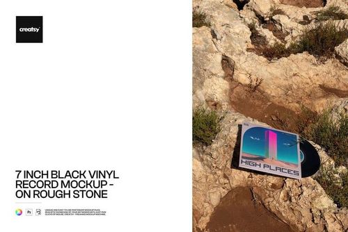 Black vinyl record mockup with a colorful sleeve placed on uneven rocky ground, viewed from above.