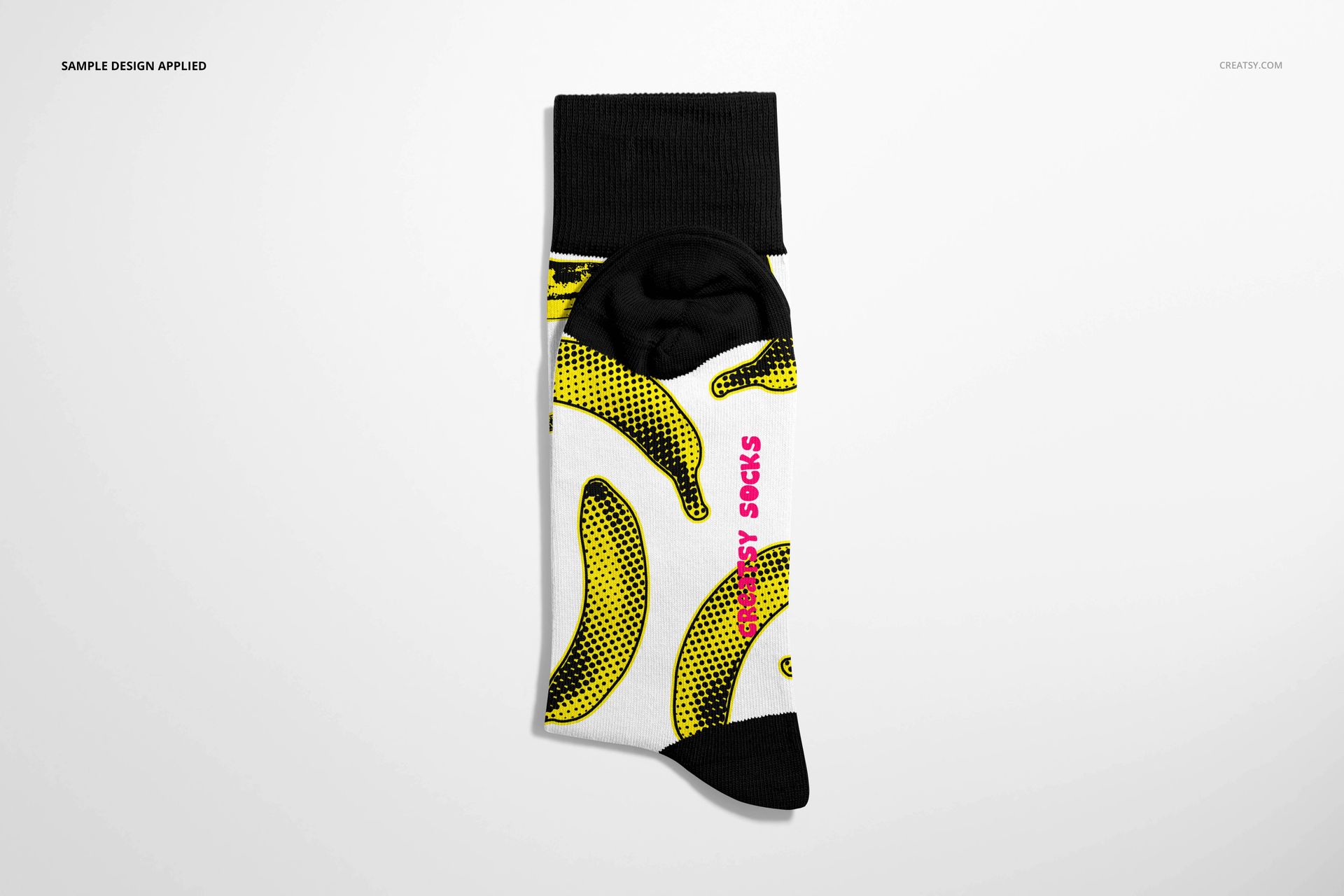High cuff sock mockup with a white base, black cuff and heel, featuring a yellow banana pattern and pink text.