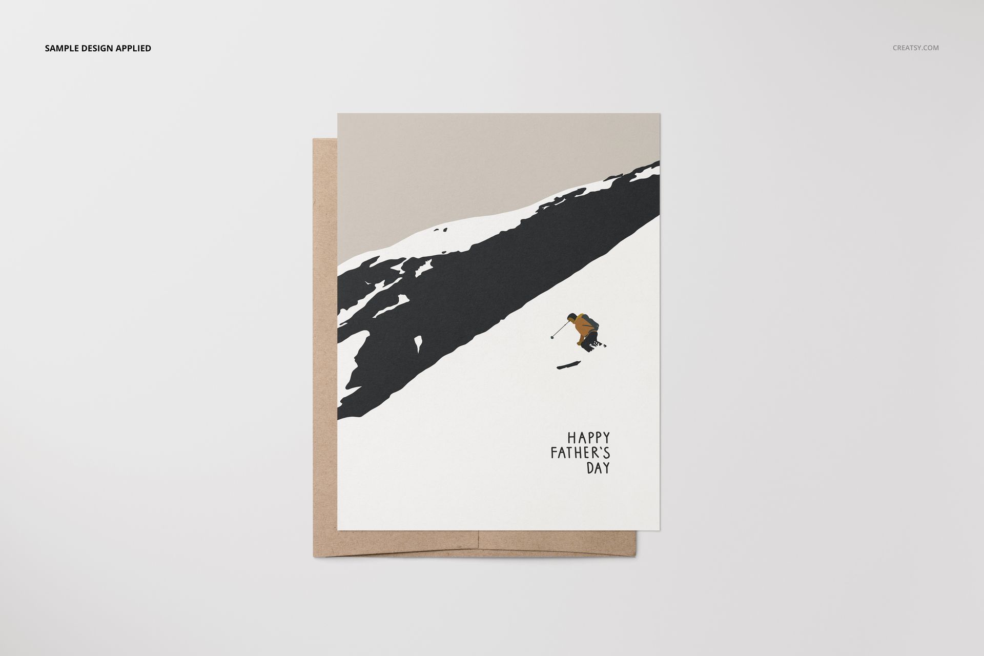 A2 card mockup featuring a skier illustration on a snow-covered slope with a brown envelope, front view.