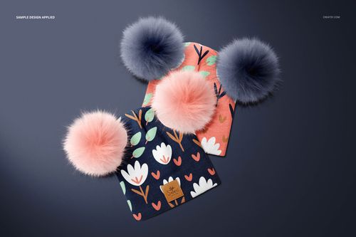 PSD mockup of beanies with fur pompons, showing playful flower patterns in pink, white, and blue shades.