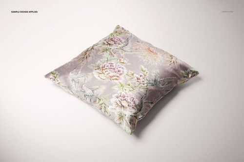 PSD mockup of a square cushion cover featuring a delicate flower and branch design, viewed from above on white.