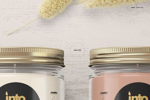Close-up of jar candle mockup featuring gold metal lids, round labels, and neutral colors on a textured background.