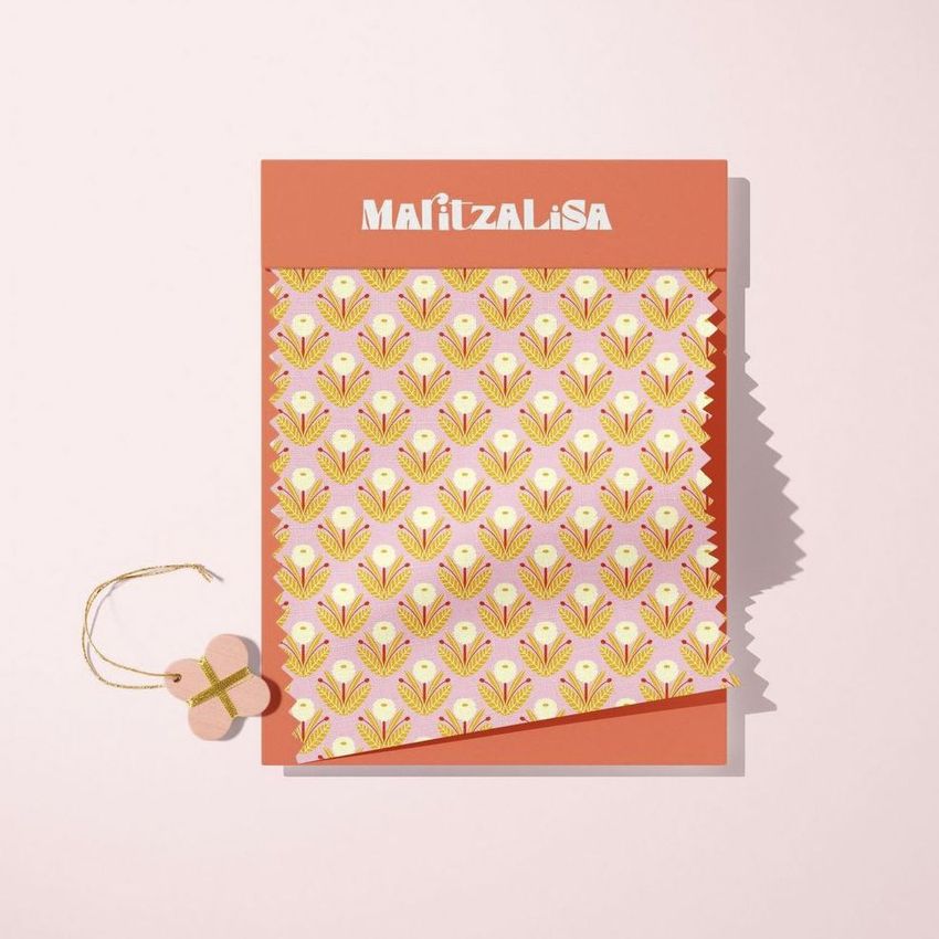 Fabric swatches mockup featuring a patterned textile with yellow and pink floral motifs on a pink background, displayed on a flat surface.