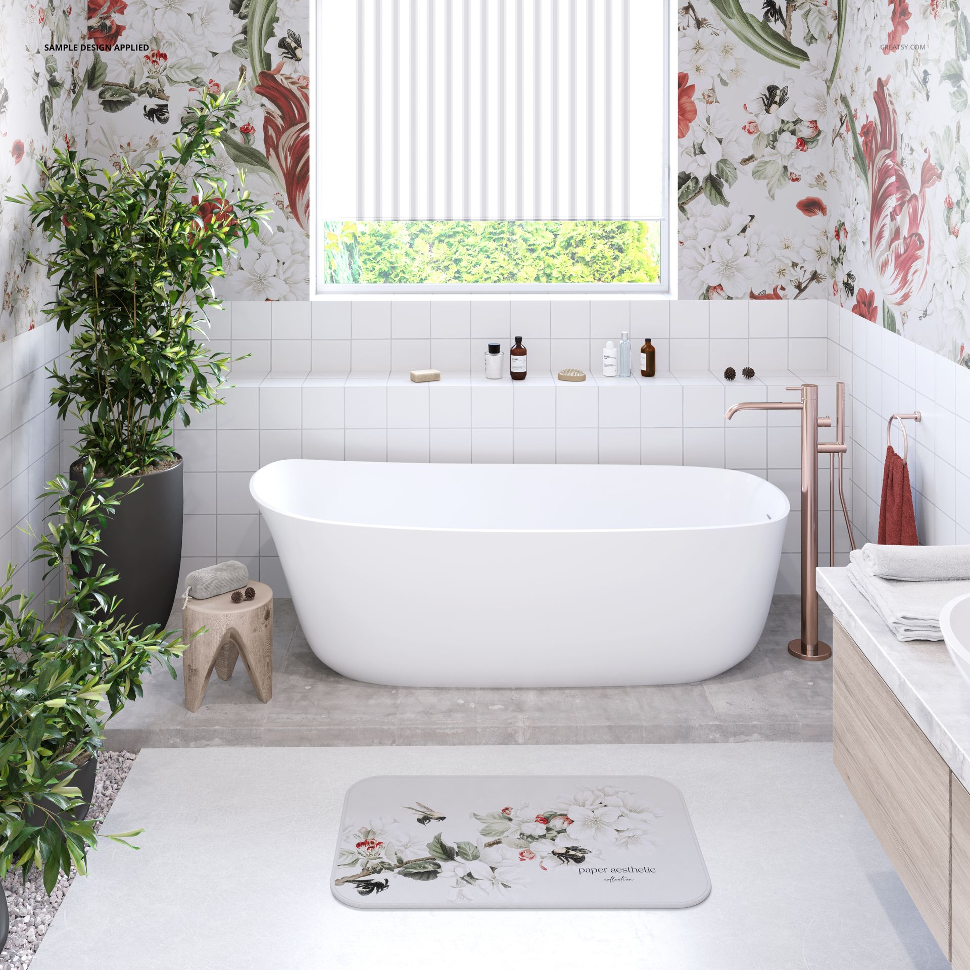 Floral bathmat mockup displayed on a light gray floor, near a freestanding tub and indoor plants in a stylish bathroom.