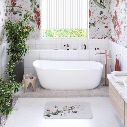 Floral bathmat mockup displayed on a light gray floor, near a freestanding tub and indoor plants in a stylish bathroom.