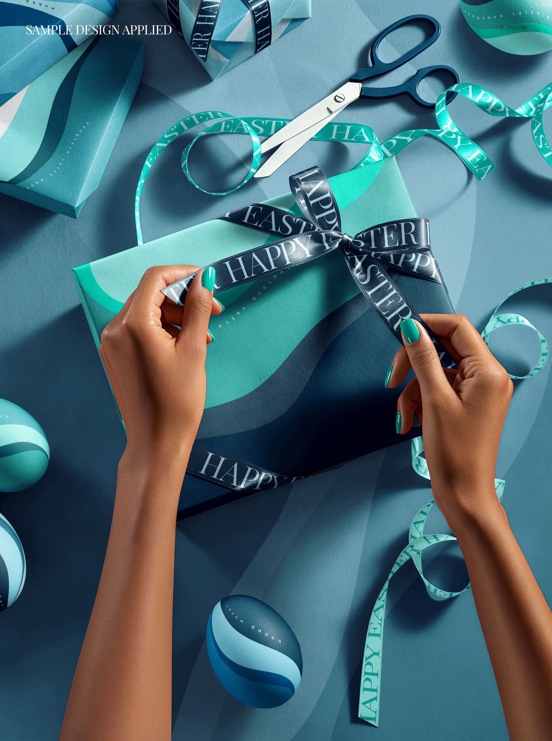 Top view of a wrapped Easter present with blue ribbon, scissors, and decorative eggs on a teal surface, PSD mockup.