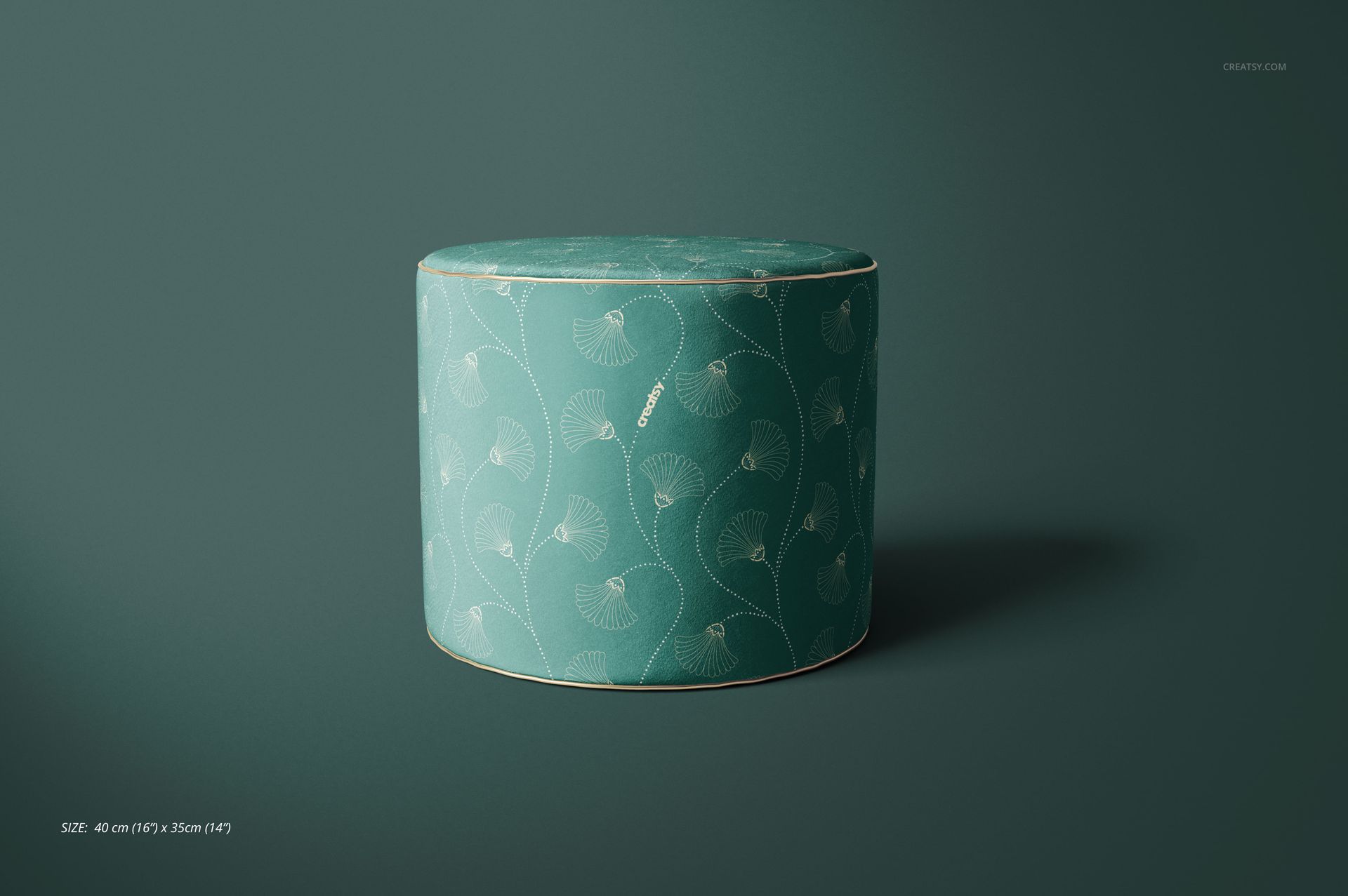 PSD mockup of a round pouf with soft velvet texture and delicate plant motif, set against a dark green background.