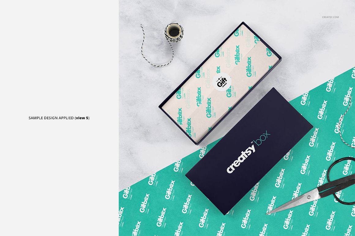 Gift box mockup set featuring a teal box lid, custom tissue paper, scissors, and spool of string on a light background.