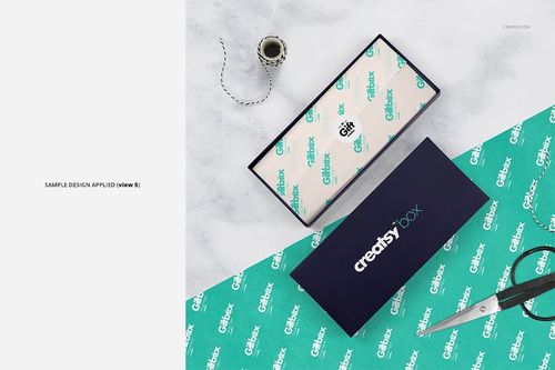 Gift box mockup set featuring a teal box lid, custom tissue paper, scissors, and spool of string on a light background.