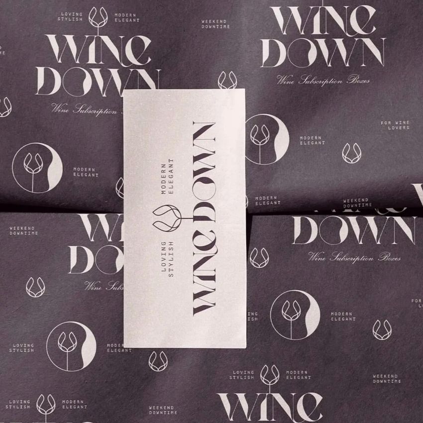 Wrapping paper mockup featuring a dark background with repeating white text and abstract logo patterns, and a rectangular sticker placed on top.