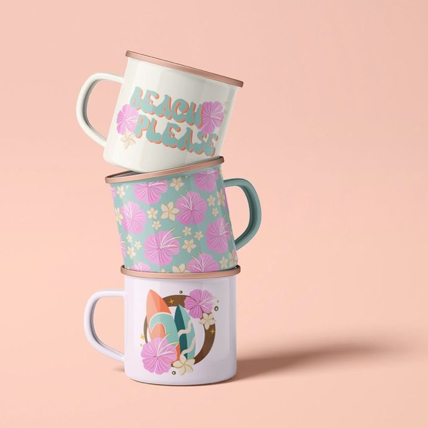 Stack of three enamel mug mockups with pastel floral and surfboard patterns, set against a soft peach background.