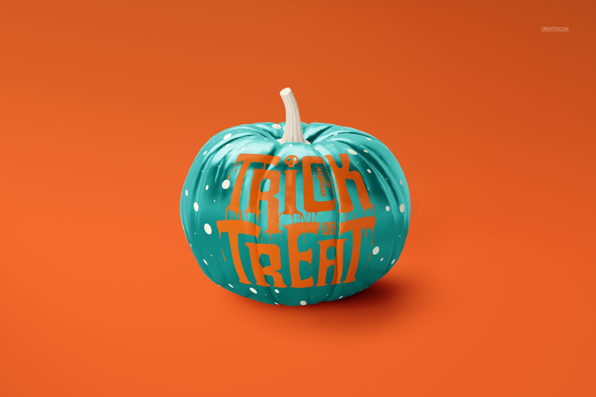 Teal pumpkin mockup featuring white polka dots and bold Halloween text, displayed on an orange surface.