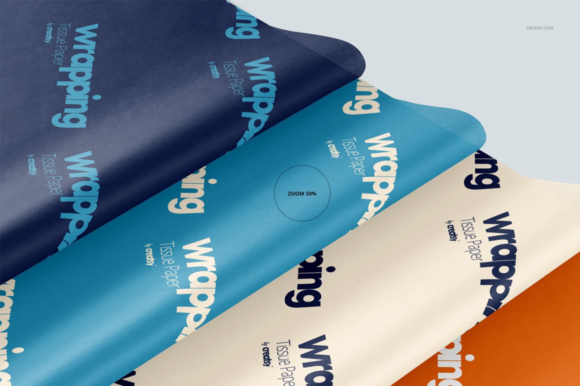 Layered wrapping tissue paper mockup with blue, white, and orange sheets, viewed from above at an angle.