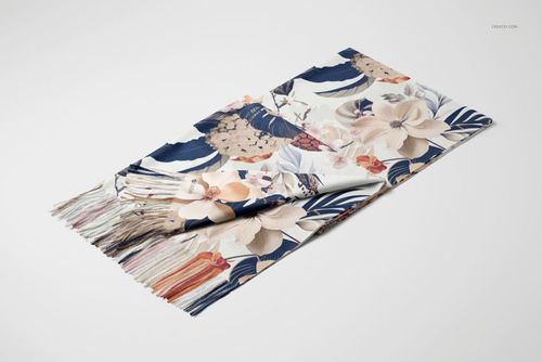 Cashmere scarf with a floral and leaf pattern in beige, navy, and blush tones, displayed folded on a white surface.