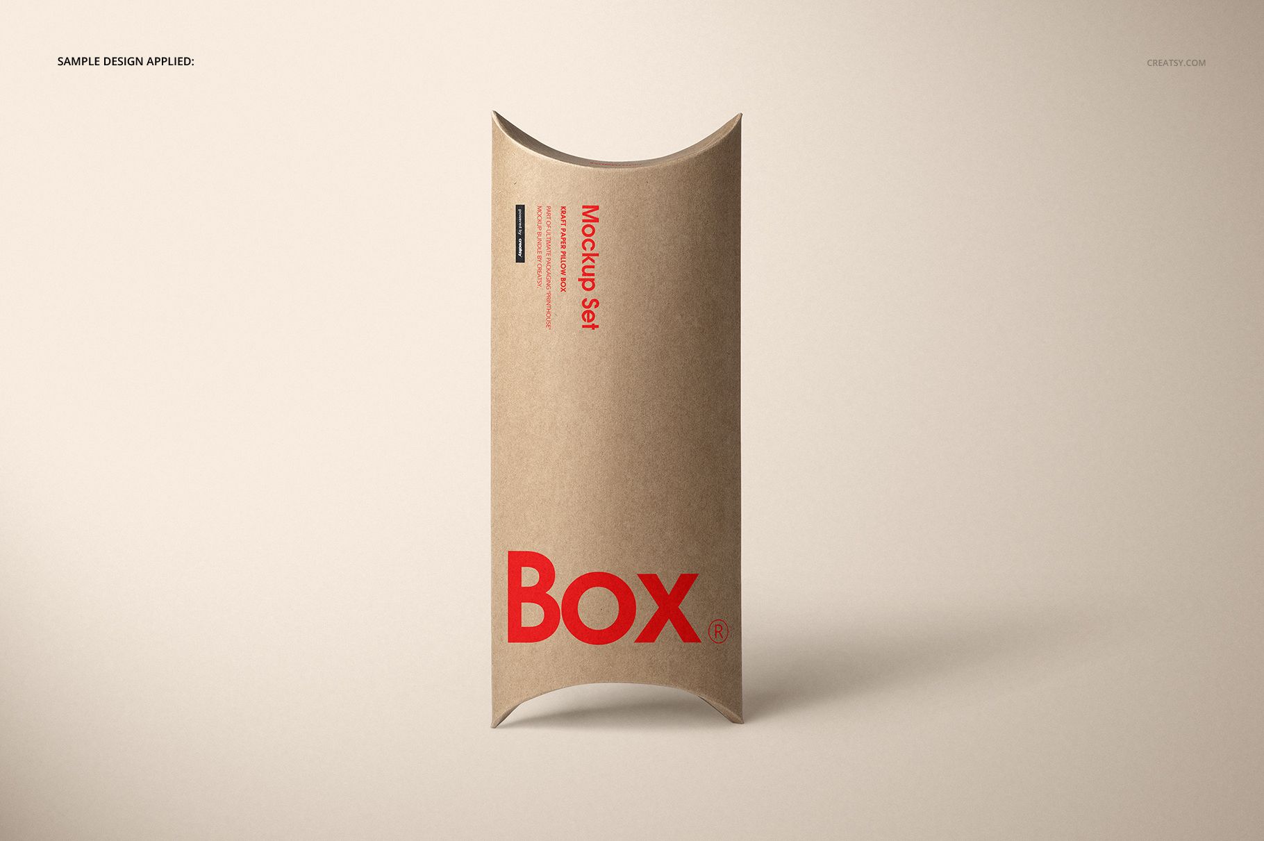 Kraft paper pillow box mockup standing upright, showing simple red lettering and a smooth neutral backdrop.