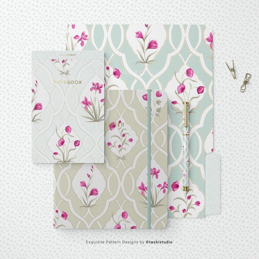Stationery set mockup featuring notebooks, a folder, and a pen with pink floral patterns on pale backgrounds, viewed from above.