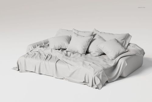 Luxury bedding set with multiple pillows and draped blanket in light gray, shown from a front angled perspective.