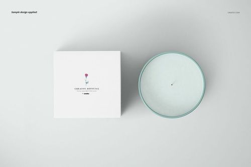 Candle mockup set showing a round candle with white wax and a matching box, both displayed from above on a pale surface.