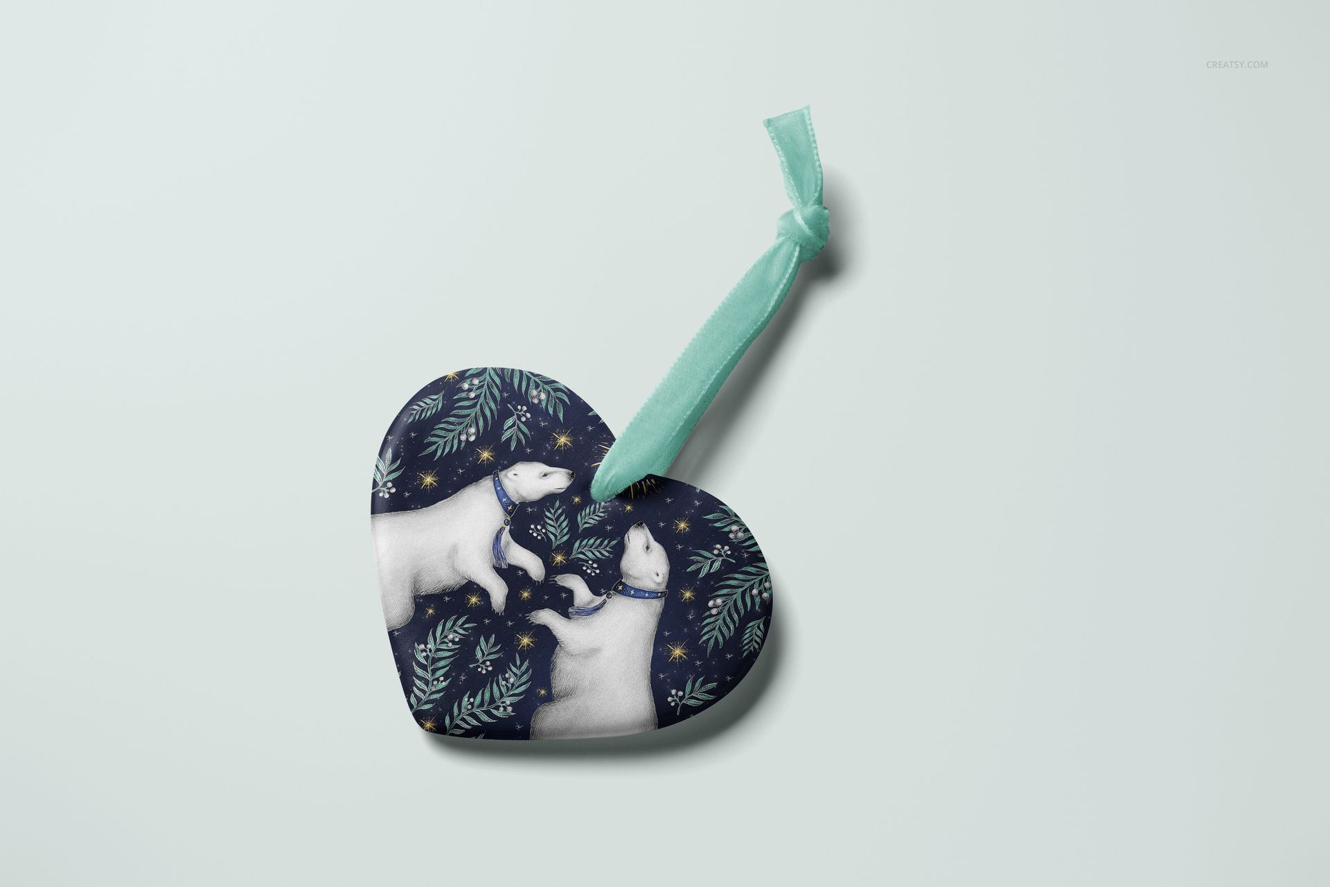 Heart-shaped Christmas ornament mockup featuring a polar bear pattern on a dark background, top view with ribbon.