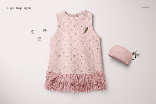 Sleeveless baby dress mockup in soft pink with small scattered patterns and feathered hem, top view on white background.
