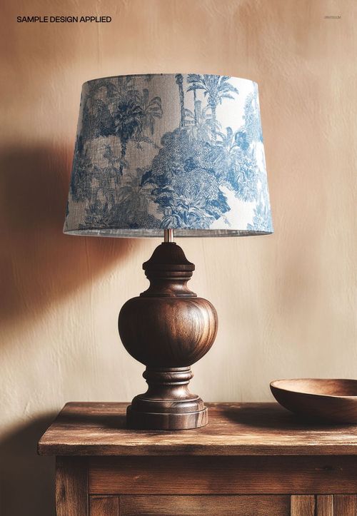 PSD mockup featuring a classic wood baluster lamp with a decorative blue and white lampshade on a wooden table.