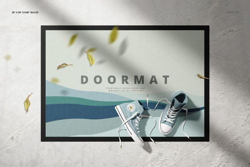 Top view of a door mat mockup featuring a geometric wave design in blue and green tones, placed on a concrete surface.