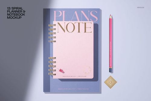 Stationery PSD mockup with a spiral-bound notebook, pink pencil, and geometric gold paperclip arranged on a light tabletop.