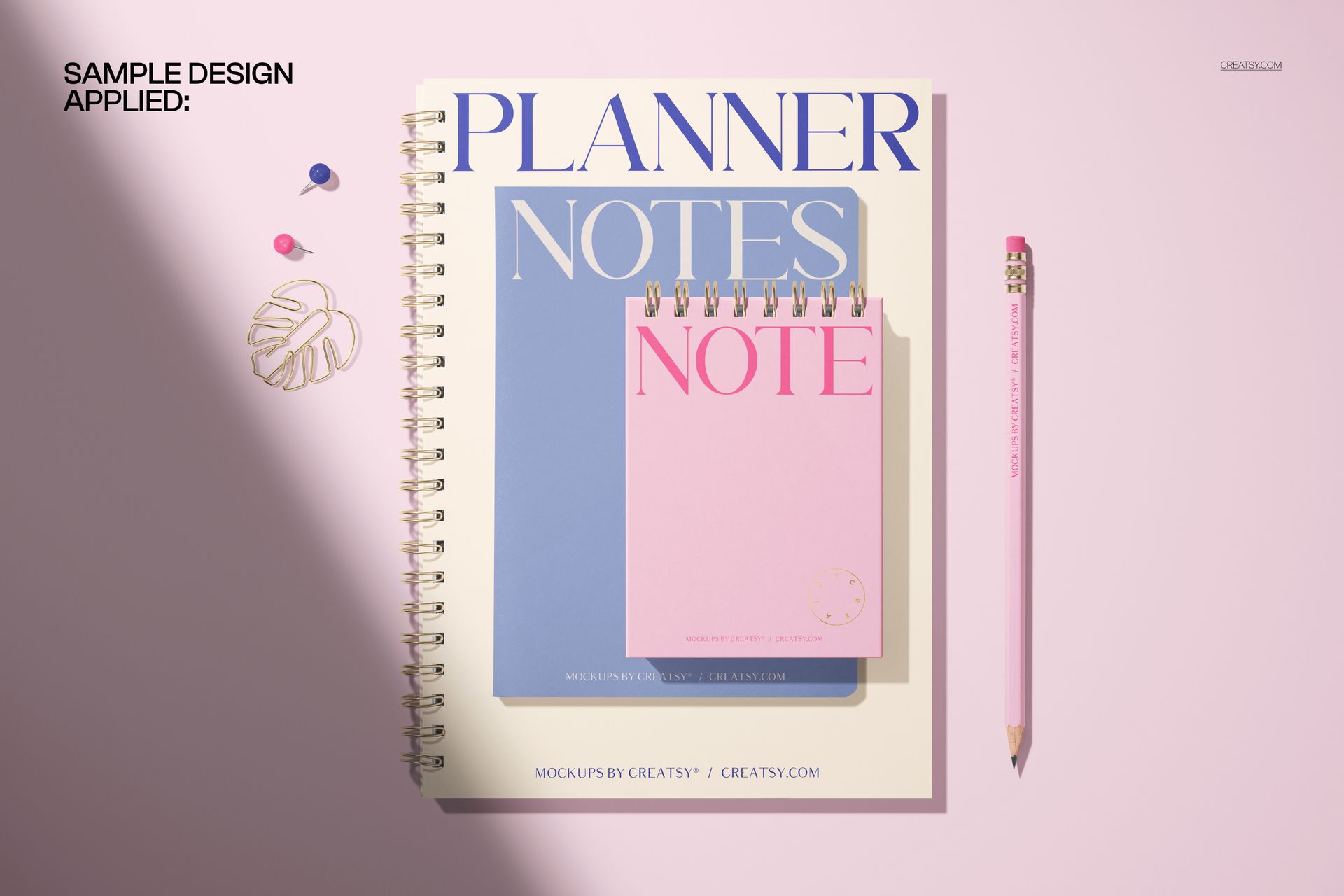 Spiral notepad planner and notebook mockup featuring two notepads in pastel colors and a pink pencil, top view.