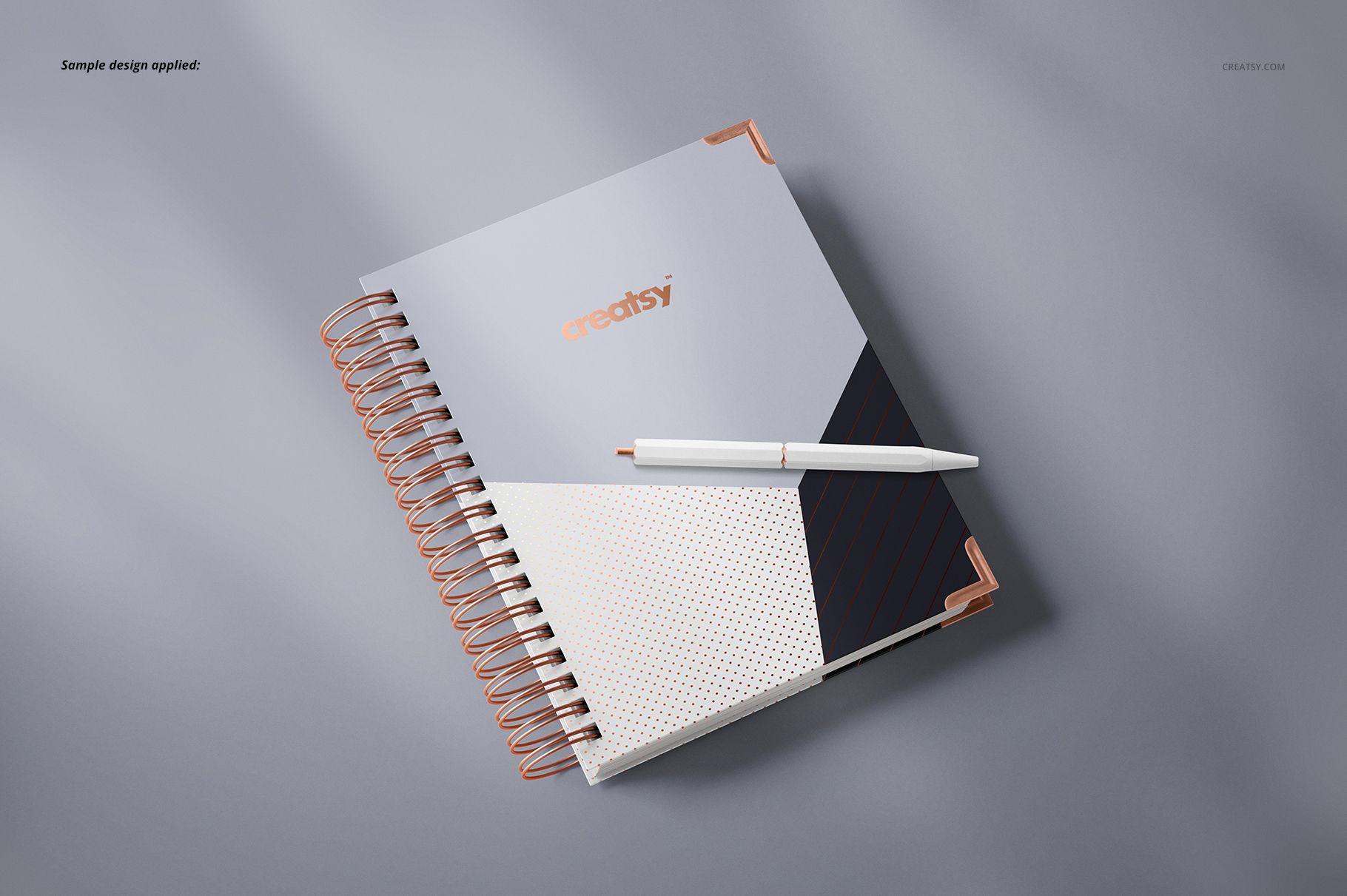 Spiral-bound planner mockup featuring a modern cover design in neutral tones, displayed on a light gray surface.