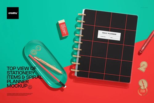 PSD mockup showing a daily planner with grid design and assorted stationery pieces from a top perspective.