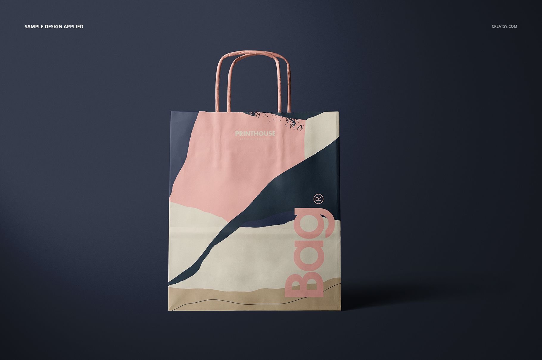 Front-facing paper bag mockup featuring twisted handles and a modern color-block pattern in pink and navy.